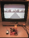 XGS Pico Edition PCB running the pre-loaded game demo on a TV.